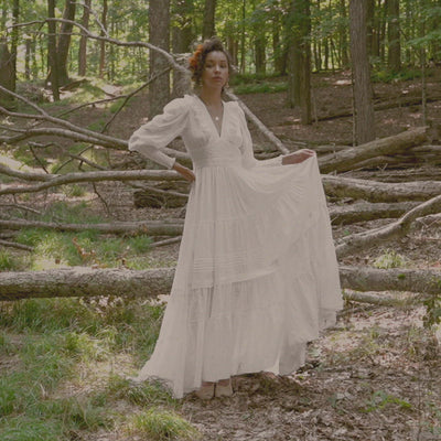 Movement video of Isa. Embroidered organic cotton voile sustainable wedding dress with long sleeves, v-neck, full skirt with train.